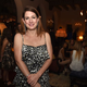 Movie executives disguised as party-goers nonchalantly mill around behind author Gillian Flynn, waiting for her to drop a new bit of prose they can dive upon and turn into a movie. (Photo: Getty Images)